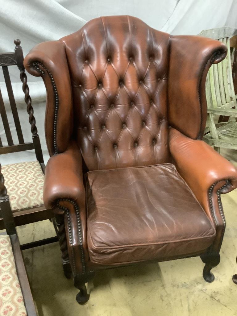 A pair of buttoned burgundy leather wing armchairs, width 86cm, depth 80cm, height 110cm